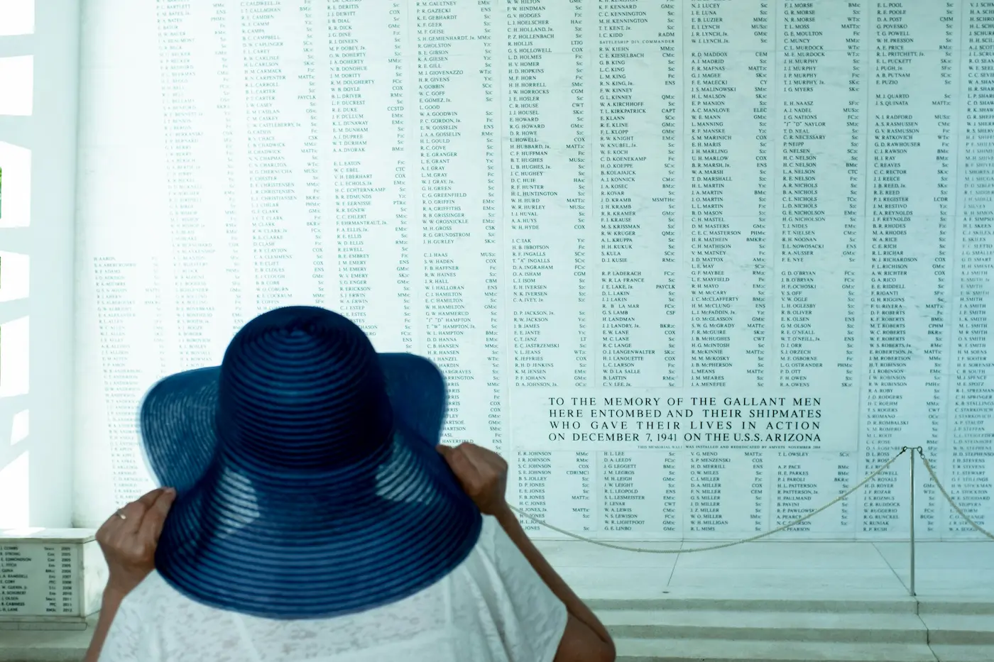 Woman viewing the names of USS Arizona fallen at Pearl Harbor in Honolulu, Oahu