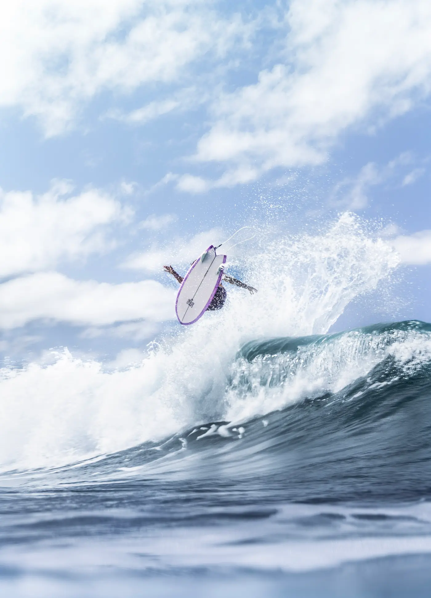 Male surfer on the North shore of Oahu surfing big waves.